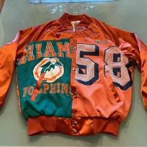 Brand new, never worn “furst of a kind” satin Miami Dolphins bomber jacket.